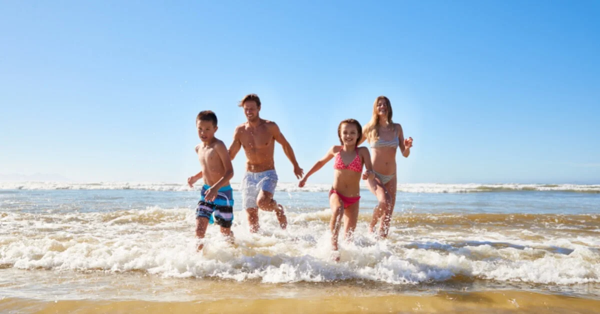 happy family on holiday in the sea wearing swimwear