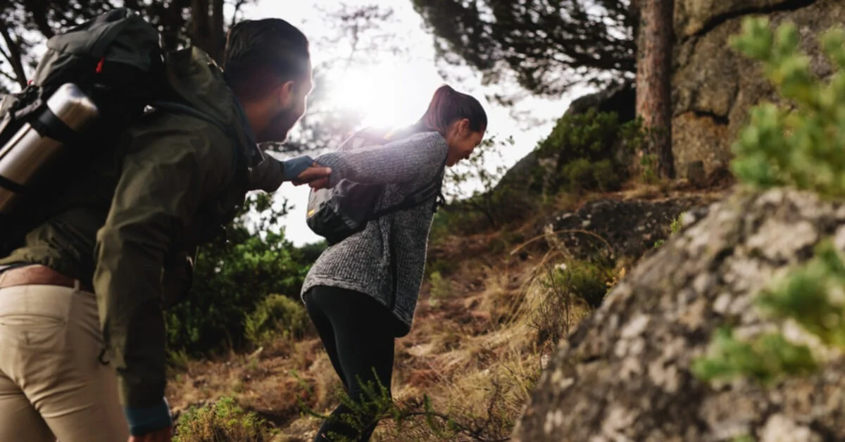 a couple hiking up a hill