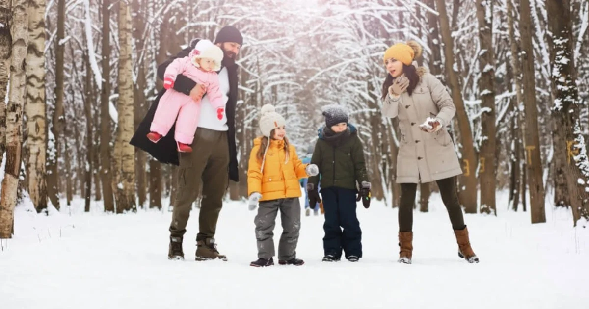 a young family on a walk in the snow