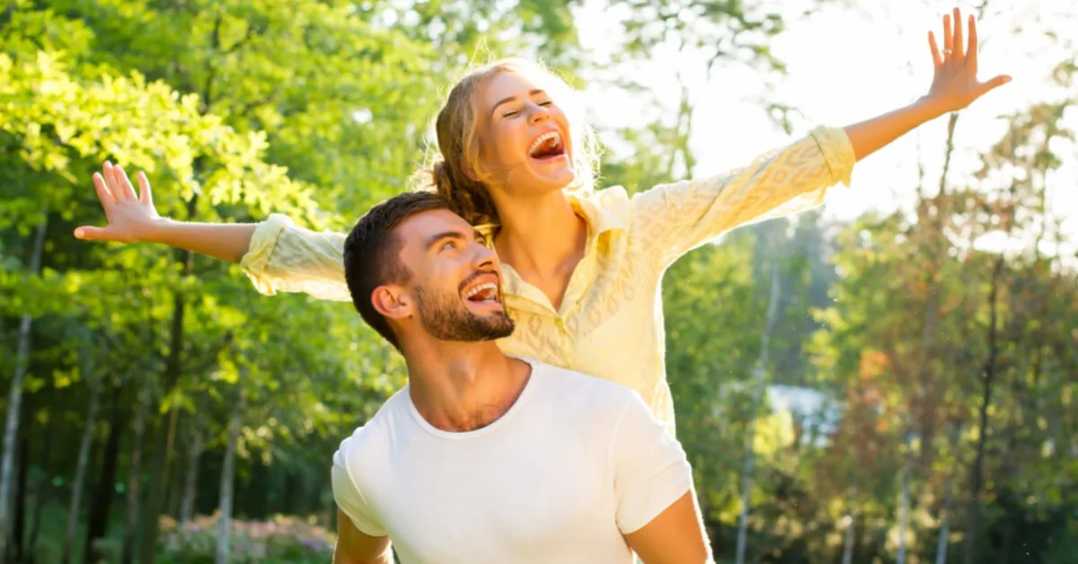 a happy couple on holiday laughing together