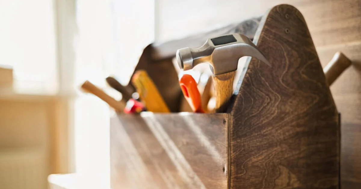 a wooden toolbox full of tools in a home