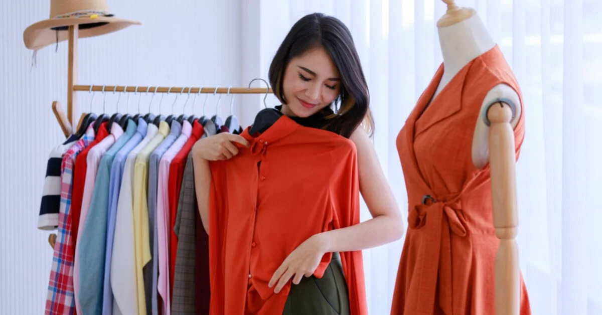 smiling woman trying on designer clothing