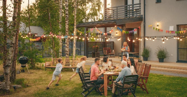 A family on holiday enjoying a meal outside their villa