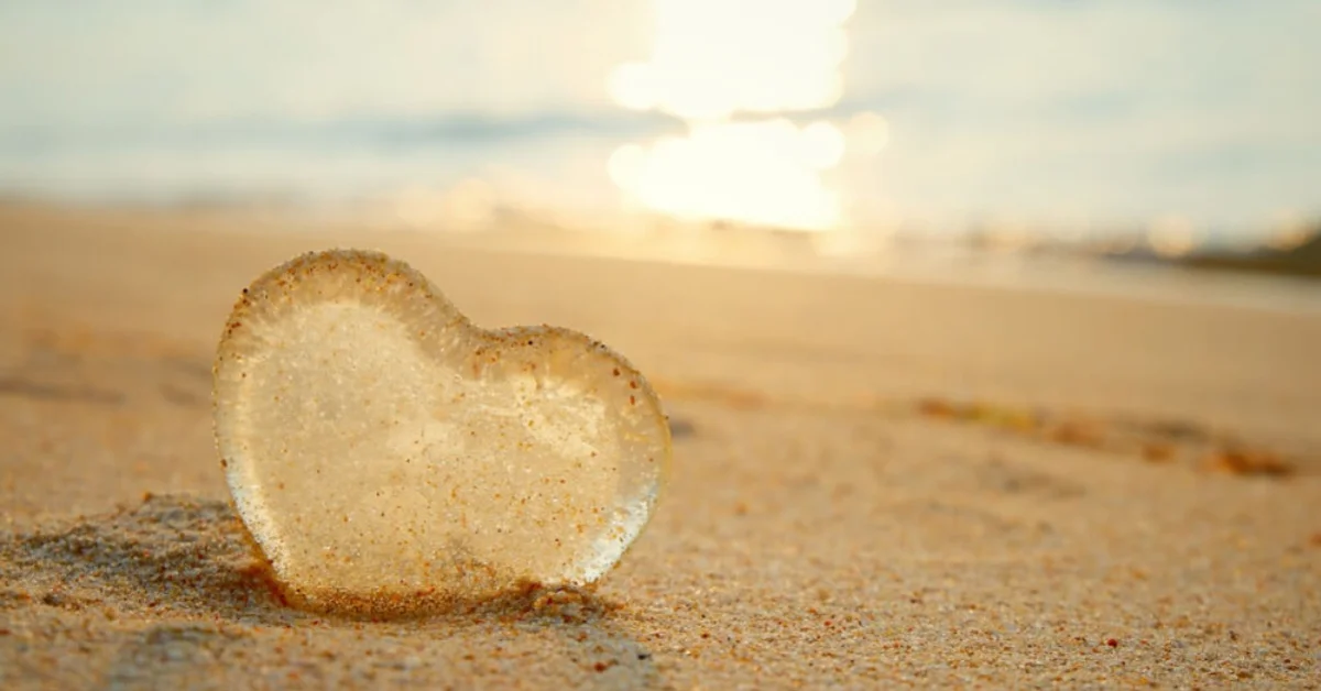 love island logo of a glass love heart on a beach