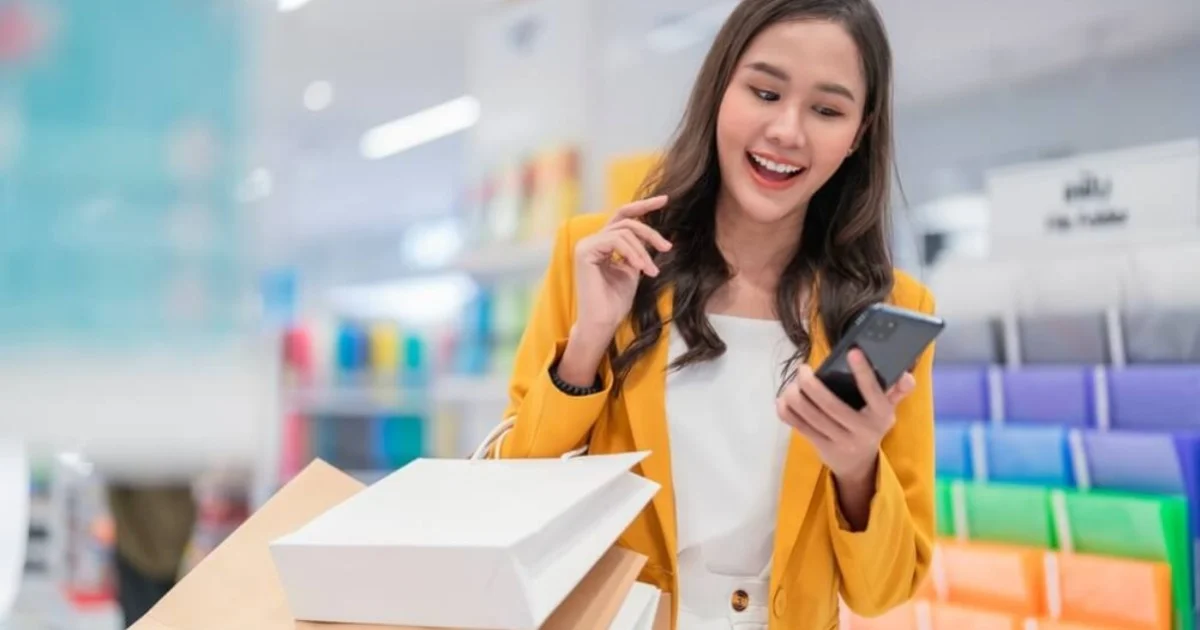 a happy young woman smiling while shopping