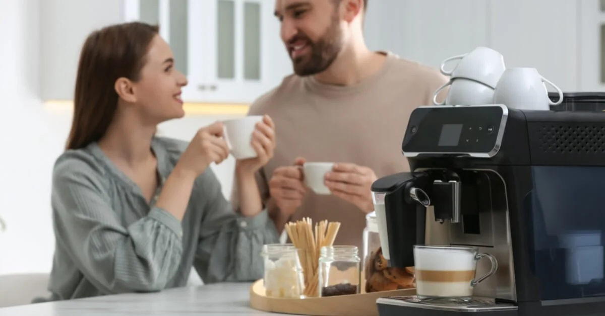 a happy couple smiling with coffee at home