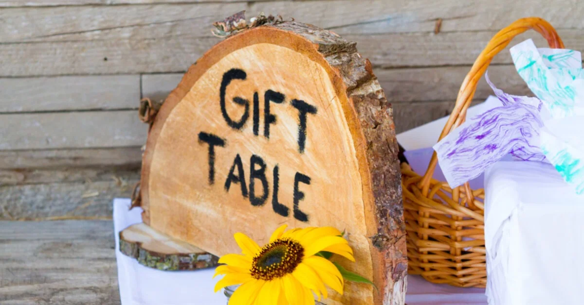 a gift table at a wedding with a sign