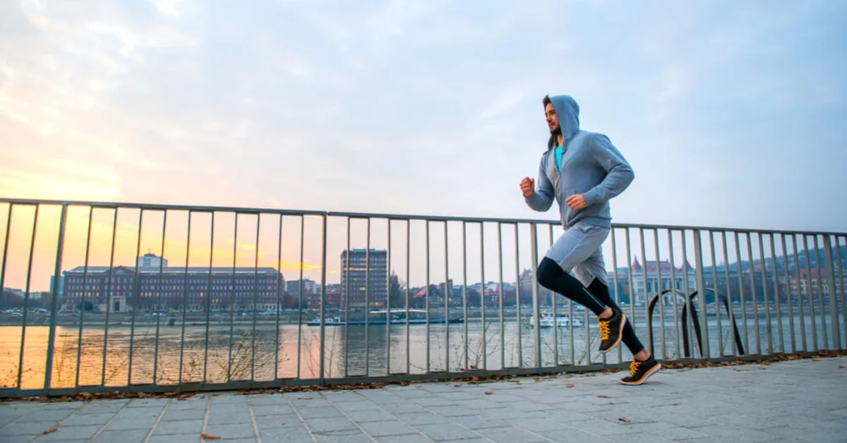 a man running down the pier in a morning