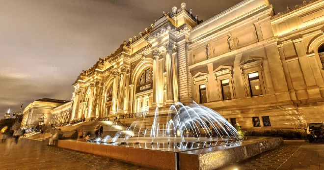 A museum lit up at night from the outside