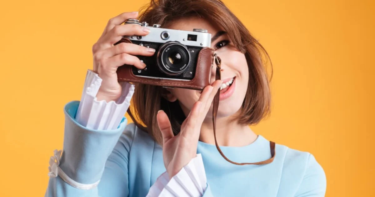 a young woman smiling into a camera lense