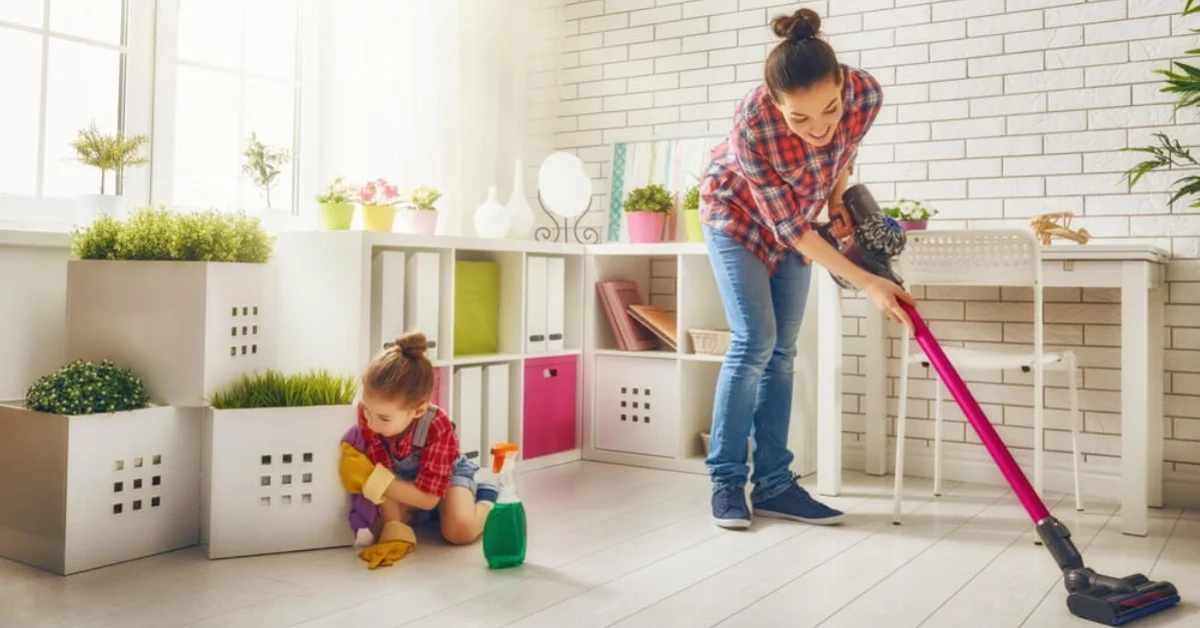 mum mopping floor with young girl on the floor
