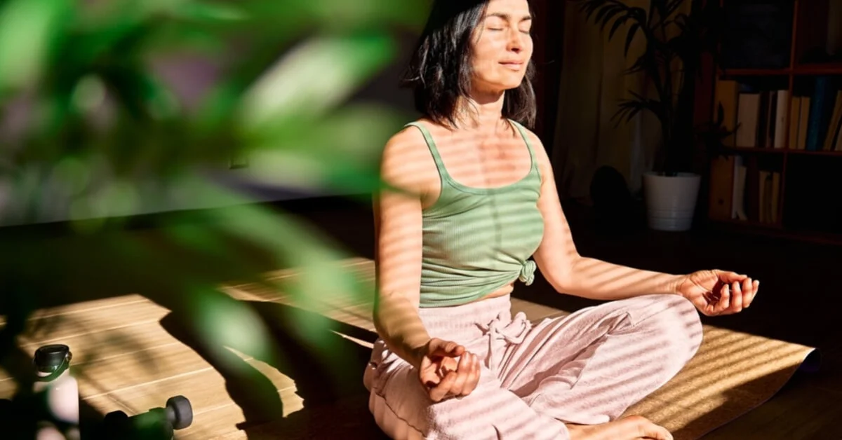young woman meditating at home