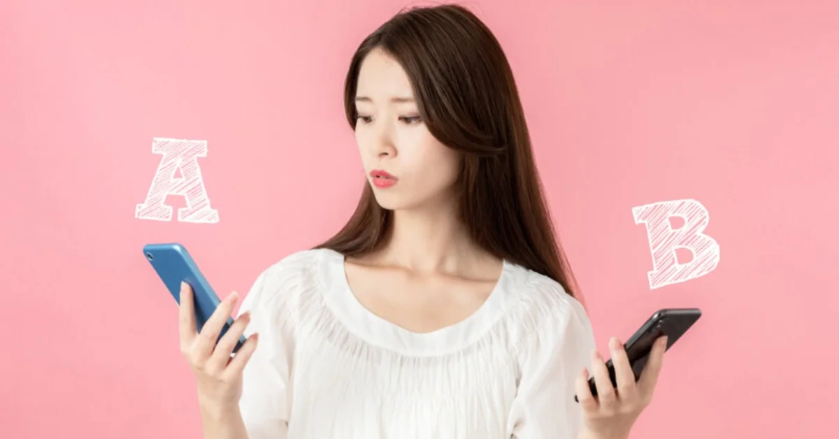an asian woman comparing between mobile phones