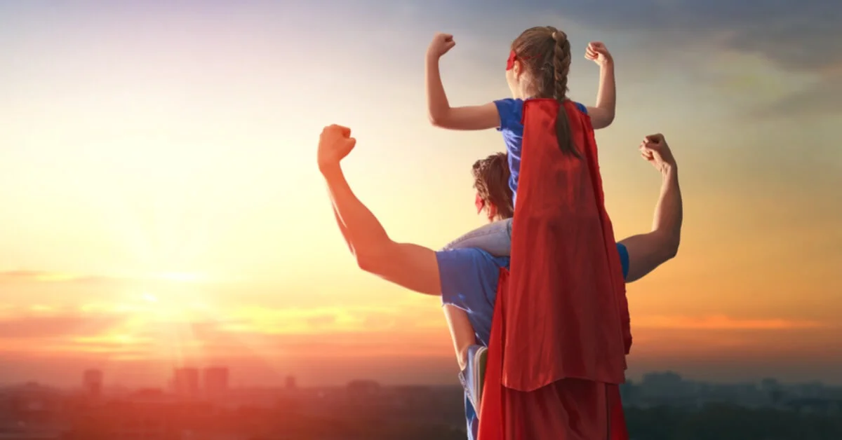 a happy father and daughter with superhero cape