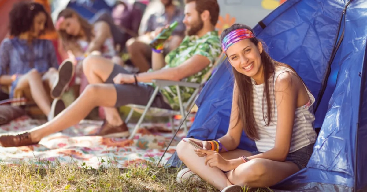 young festivalgoers outside their tents