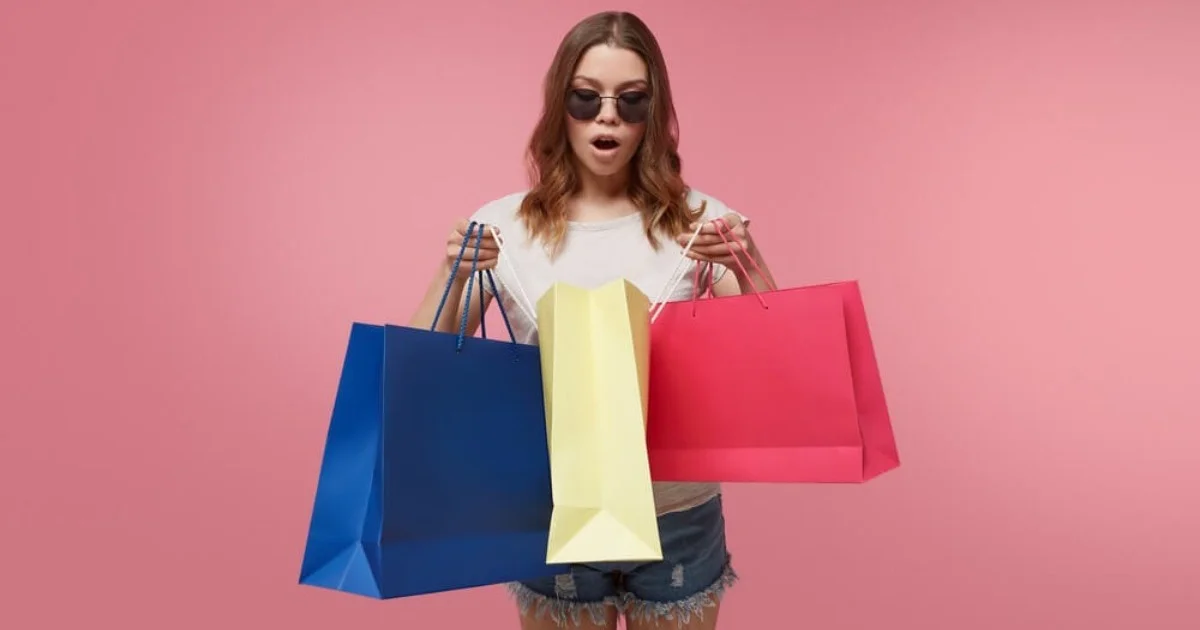 a young woman holding shopping bags