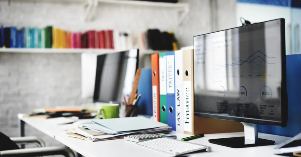 a modern white office with stationery and files in the background
