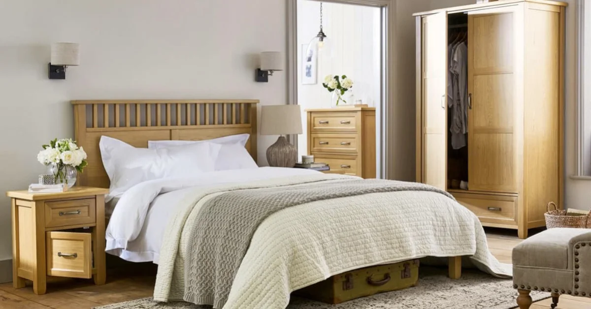 a light and airy bedroom with wooden furniture